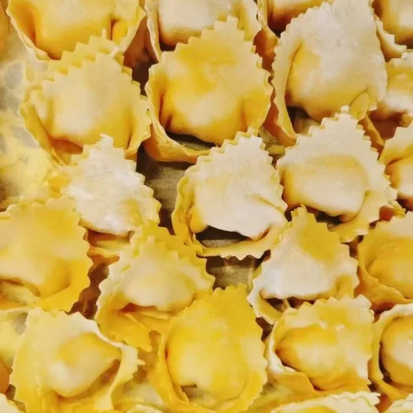 Handmade ravioli displayed on a preparation table