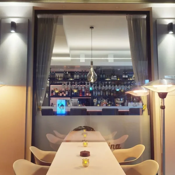 Outdoor dining table beside the entrance of Bella Cucina Italian restaurant in Dalkey