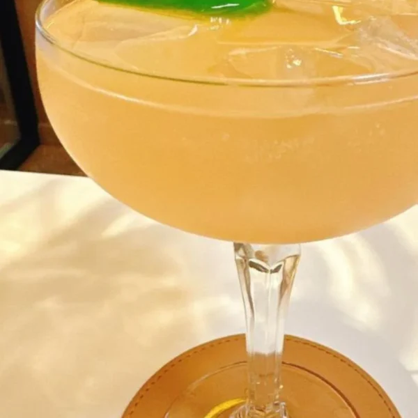 Citrus cocktail garnished with a green chilli