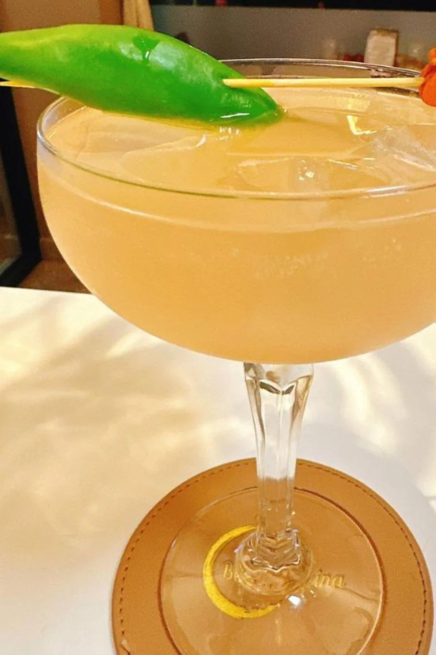 Citrus cocktail garnished with a green chilli