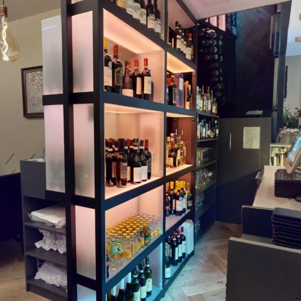 Wine bottles displayed on illuminated shelves