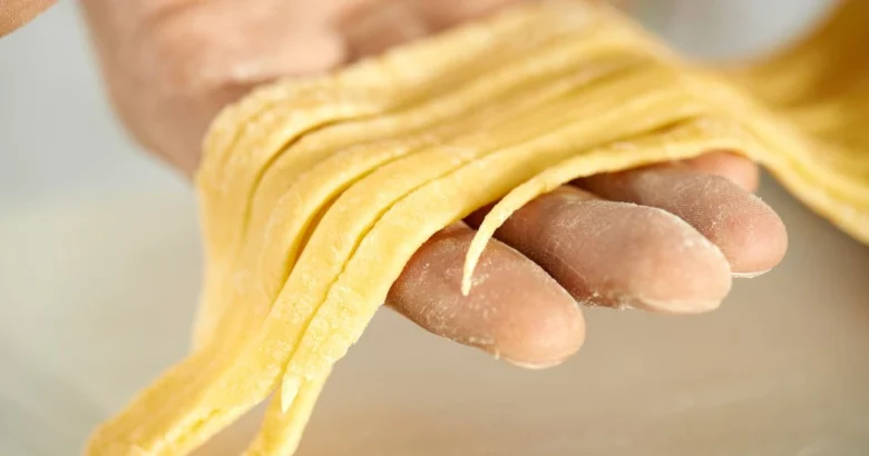 Fresh homemade pasta being prepared by hand